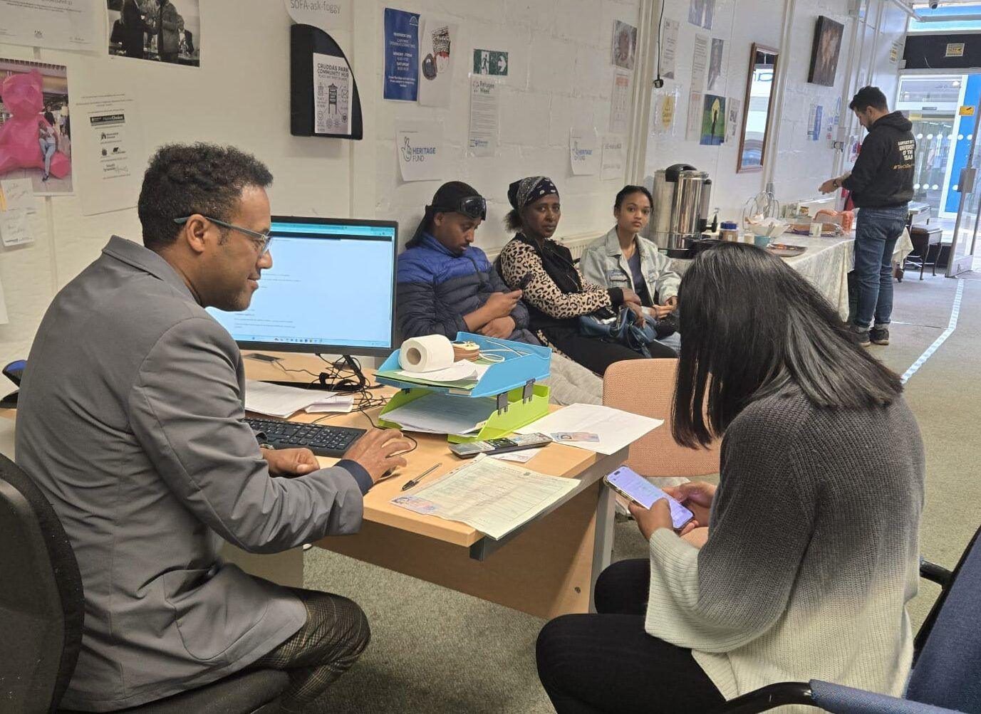 Staff supporting visitors at the Integration Station office
